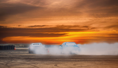 Car drifting, Blurred of image diffusion race drift car with lots of smoke from burning tires on speed track - 243627430