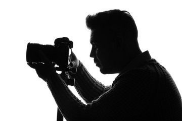 Silhouette of male photographer on white background