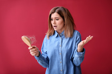 Woman with hair loss problem on color background