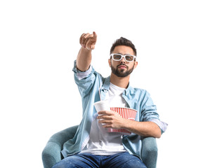 Young man with popcorn watching movie on white background
