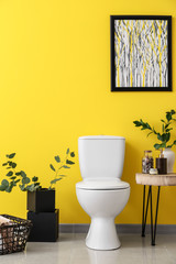 Fototapeta na wymiar Modern interior of restroom with ceramic toilet bowl
