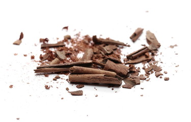 Cinnamon sticks with powder and shavings, macro isolated on white background