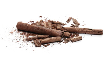 Cinnamon sticks with powder and shavings, macro isolated on white background