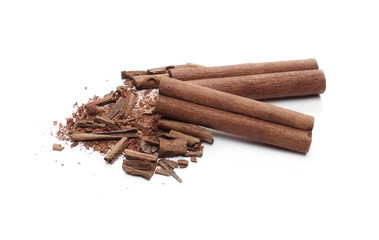Cinnamon sticks with powder and shavings, macro isolated on white background