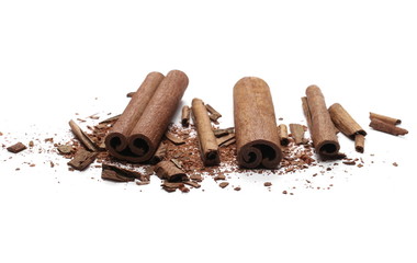 Cinnamon sticks with powder and shavings, macro isolated on white background