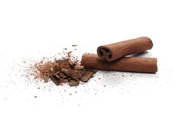 Cinnamon sticks with powder and shavings, macro isolated on white background