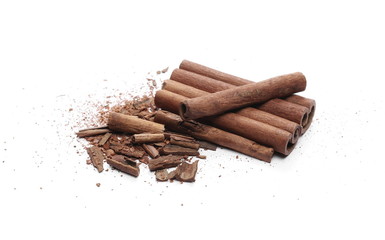 Cinnamon sticks with powder and shavings, macro isolated on white background