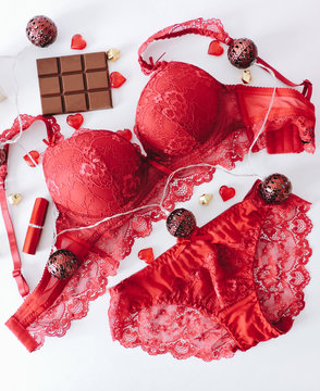 Red women underwear with lace isolated on white background. red bra and pantie.Copy space. Beauty, fashion blogger concept. Romantic lingerie for Valentine's day temptation. Erotic concept.