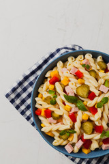 Italian fusilli pasta in a salad with ham and vegetables.