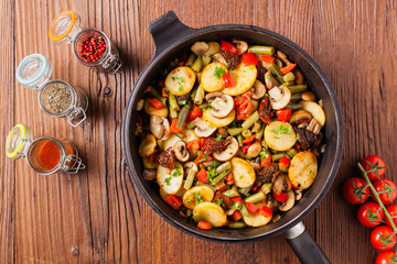 Fried pan vegetables, with mushrooms and dried tomatoes. Seasoned with a mix of herbs.