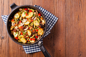 Fried pan vegetables, with mushrooms and dried tomatoes. Seasoned with a mix of herbs.