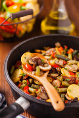 Fried pan vegetables, with mushrooms and dried tomatoes. Seasoned with a mix of herbs.
