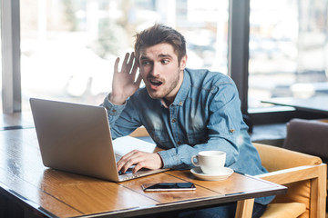 What you say? Side view portrait interesting of bearded young freelancer in blue jeans shirt are...