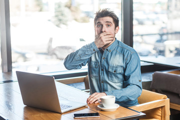 Crash! Side view portrait of emotional scared young businessman in blue jeans shirt are sitting in...