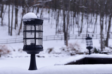 Snow lantern on the background of a winter landscape. Winter landscape with lantern. Winter background.