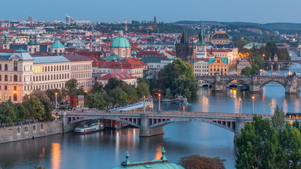 Fototapeta na wymiar Aerial evening view of the Vltava River and illuminated bridges day to night timelapse, Prague
