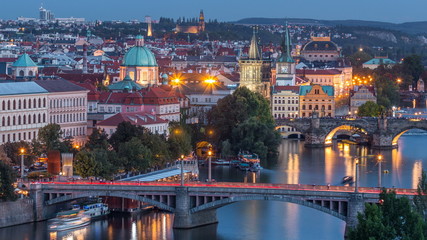 Aerial evening view of the Vltava River and illuminated bridges day to night timelapse, Prague