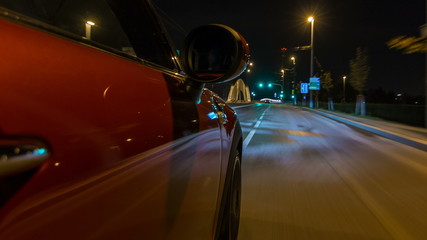 Naklejka premium Car moves at fast speed at the night streets timelapse hyperlapse drivelapse.