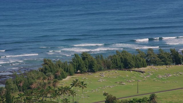 Molokai, Hawaii circa-2018.  Aerial view of Kalaupapa oceanfront cemetery on Molokai.  Shot with Cineflex and RED Epic-W Helium. 