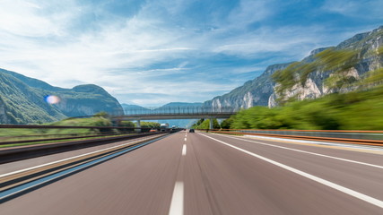Driving on a highway through the mountains and meadows in Italy timelapse hyperlapse drivelapse