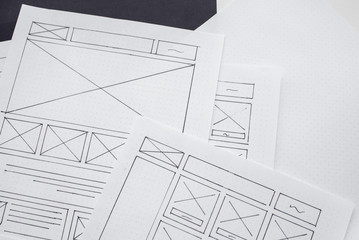 UX website designer drawing wireframe sketch of prototype, framework, layout future project....