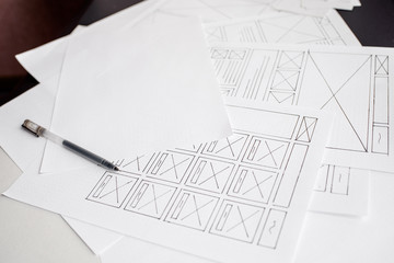UX website designer drawing wireframe sketch of prototype, framework, layout future project....