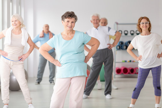 Group of happy seniors during sport's training at gym