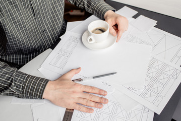 UX website designer drawing wireframe sketch of prototype, framework, layout future project....
