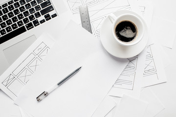 UX website designer drawing wireframe sketch of prototype, framework, layout future project. Creative user experience concept website template. Designer workspace