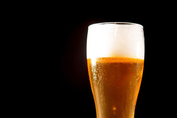 Glass beer on black background with copyspace