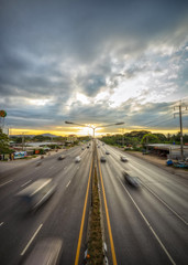 Jostling car running fast on the road and sky was overcast with clouds before the rain is heavy.