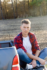 Fototapeta premium The man with offroad car in field