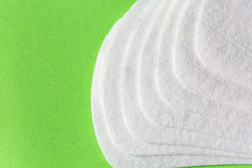 Protection of feminine hygiene, menstruation, sanitary pads on a colored background, a woman on critical days, the menstrual cycle.