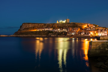 Fototapeta premium Evening in Whitby, North Yorkshire, England, UK - seen from the Pier Road