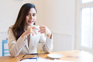 Protrait of Beautiful businesswoman sitting at desk and working with laptop computer.