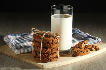 A glass with milk and chocolate cookies