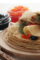 Russian pancakes with red and black caviar	