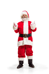 Hey, hello. Holly jolly x mas festive noel. Full length of funny happy santa in headwear, costume, black belt, white gloves, waves with arm palm standing at studio over white background