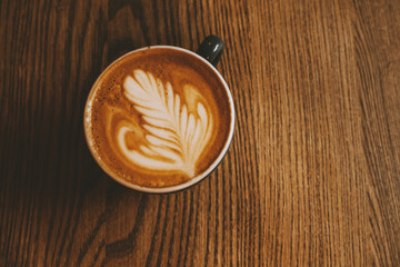 cup of coffee on wooden background