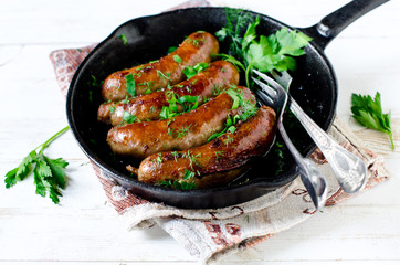 Homemade sausages from turkey (chicken) fried in a frying pan 