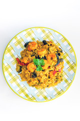Tasty risotto with Shrimp, fresh herbs vegetables on a white plate