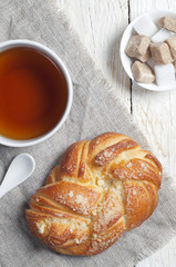 Fresh bun and cup of tea