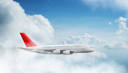 Huge two-storey passengers commercial airplane flying above dramatic clouds.