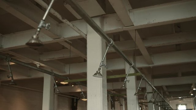 Wide moving shot of shower heads in Alcatraz prison