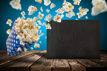 Popcorn explosion on old wooden table.