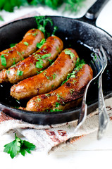 Homemade sausages from turkey (chicken) fried in a frying pan 