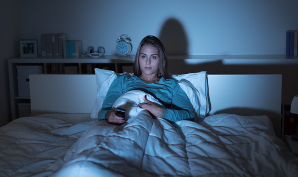 Woman Watching Tv In Bed