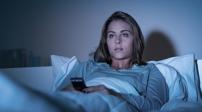 Woman Watching Tv In Bed