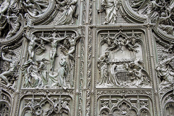 Detail bronze bas-reliefs of the Pieta scene in bas relief at Milan's Cathedral doors