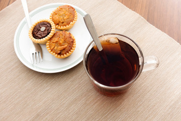 Tea time with hot tea and dessert tarts